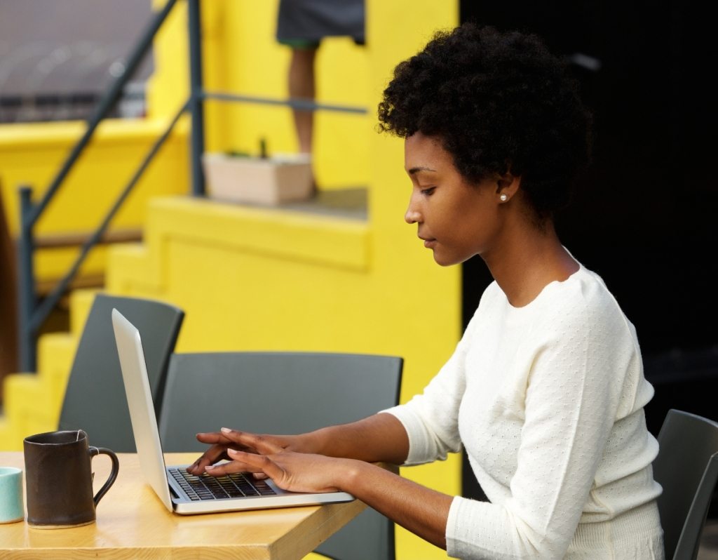 attractive-young-woman-using-laptop-outside-P9RLFGU@2x-1024×798-1.jpg